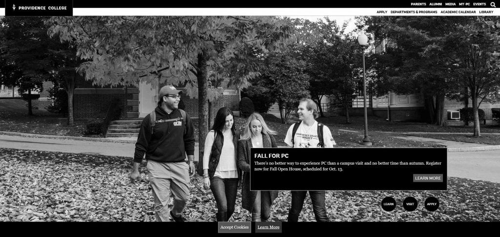 black and white image of four students walking